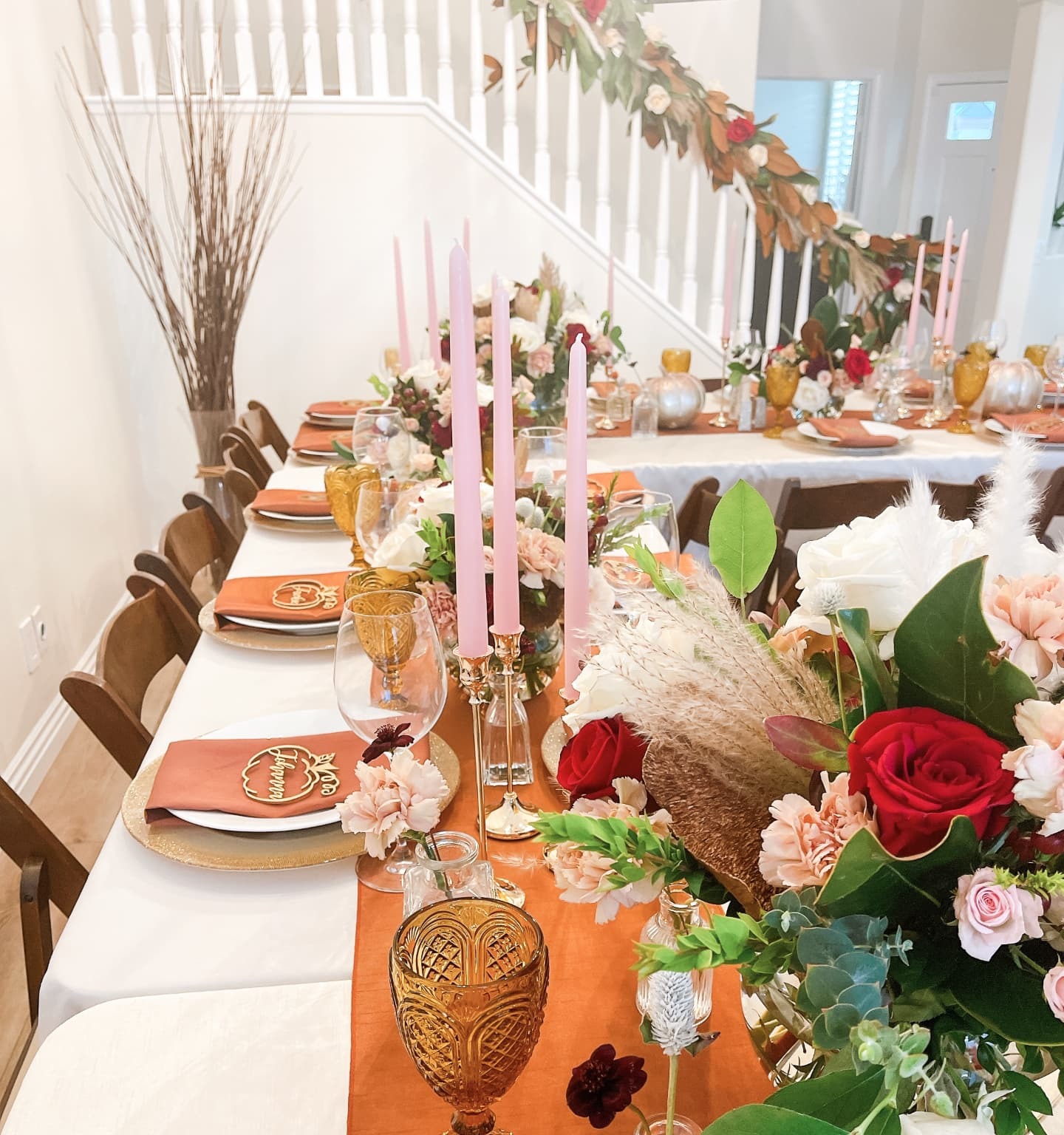 Long table with pink tapers, amber glass and abundant florals