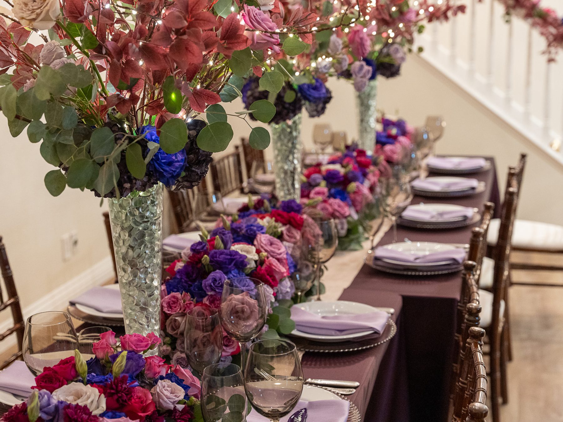 Plum and berry table beneath the staircase
