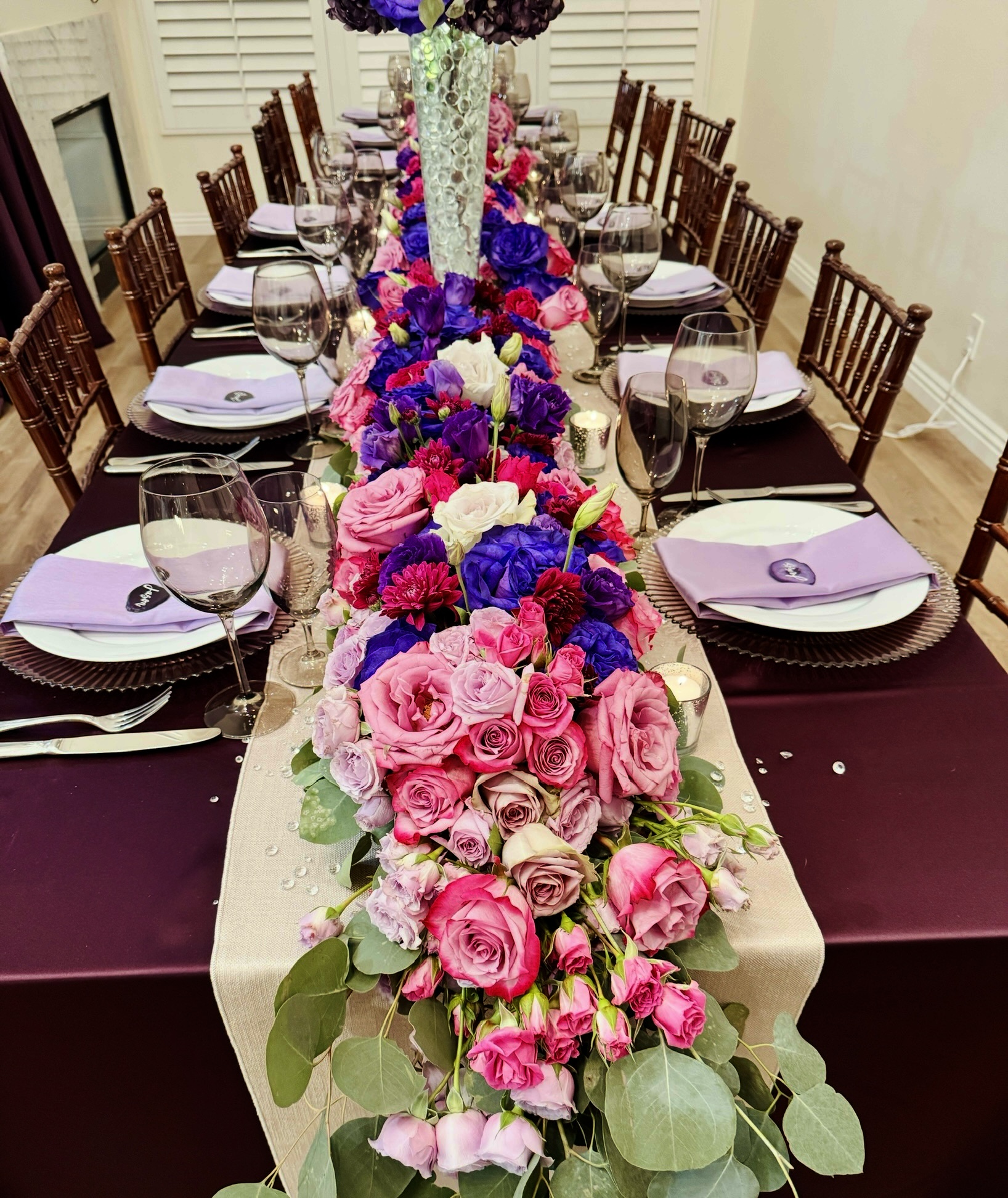 Rose runner in magenta, sapphire and lilac down a linen table runner