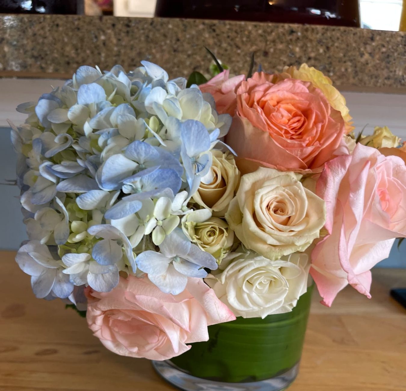 Blue hydrangea, peach and white rose