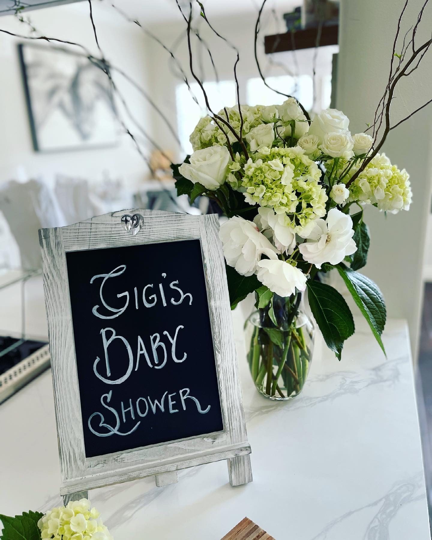Celebration sign with white florals