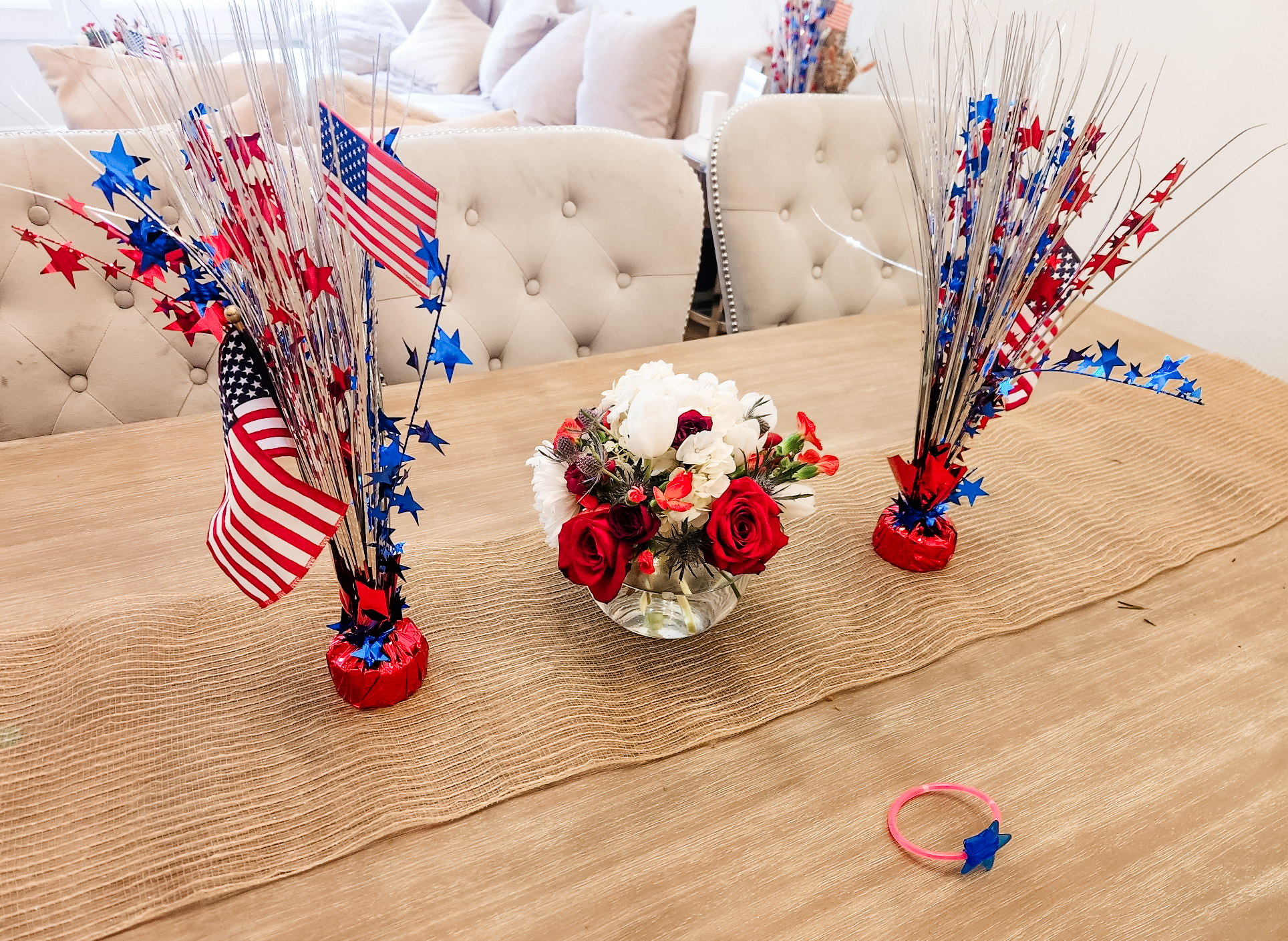 Dining table set for the Fourth with a low red, white and blue bowl and star sprays